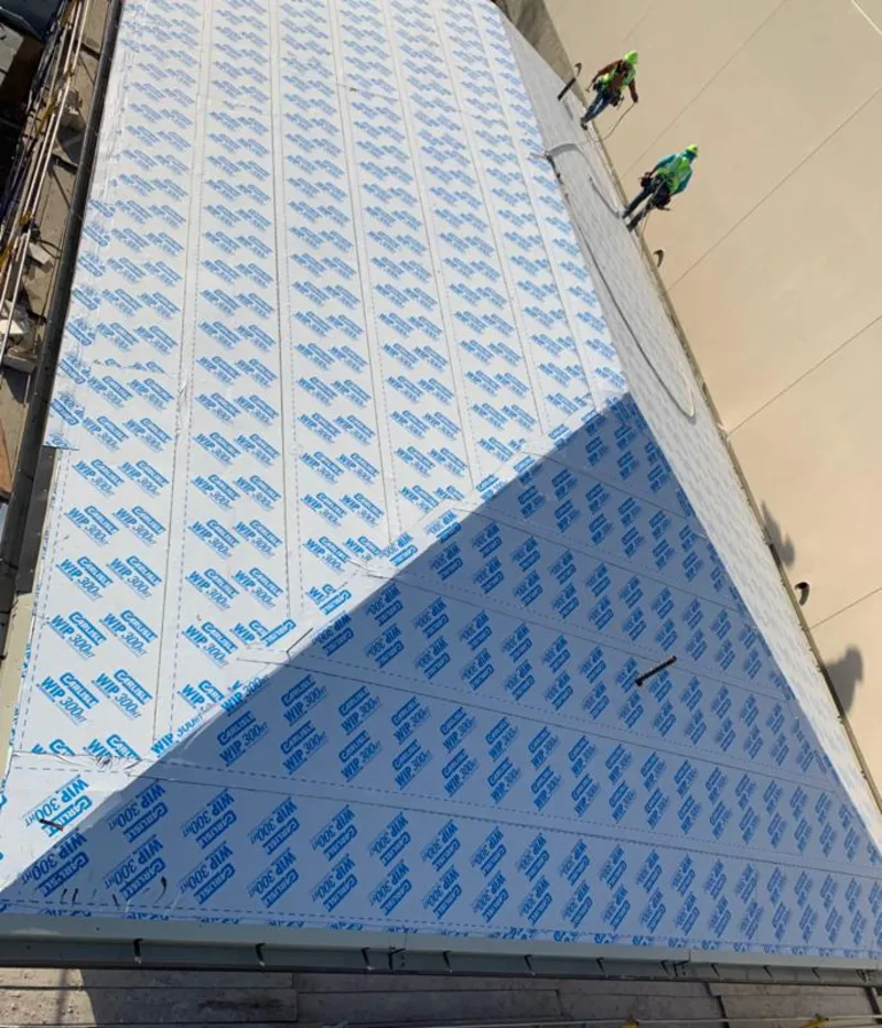 Professional roofers installing underlayment on a metal roof in Lyndon